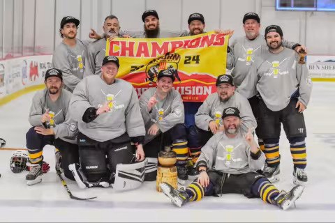 The boyos on the ice with a champion banner
